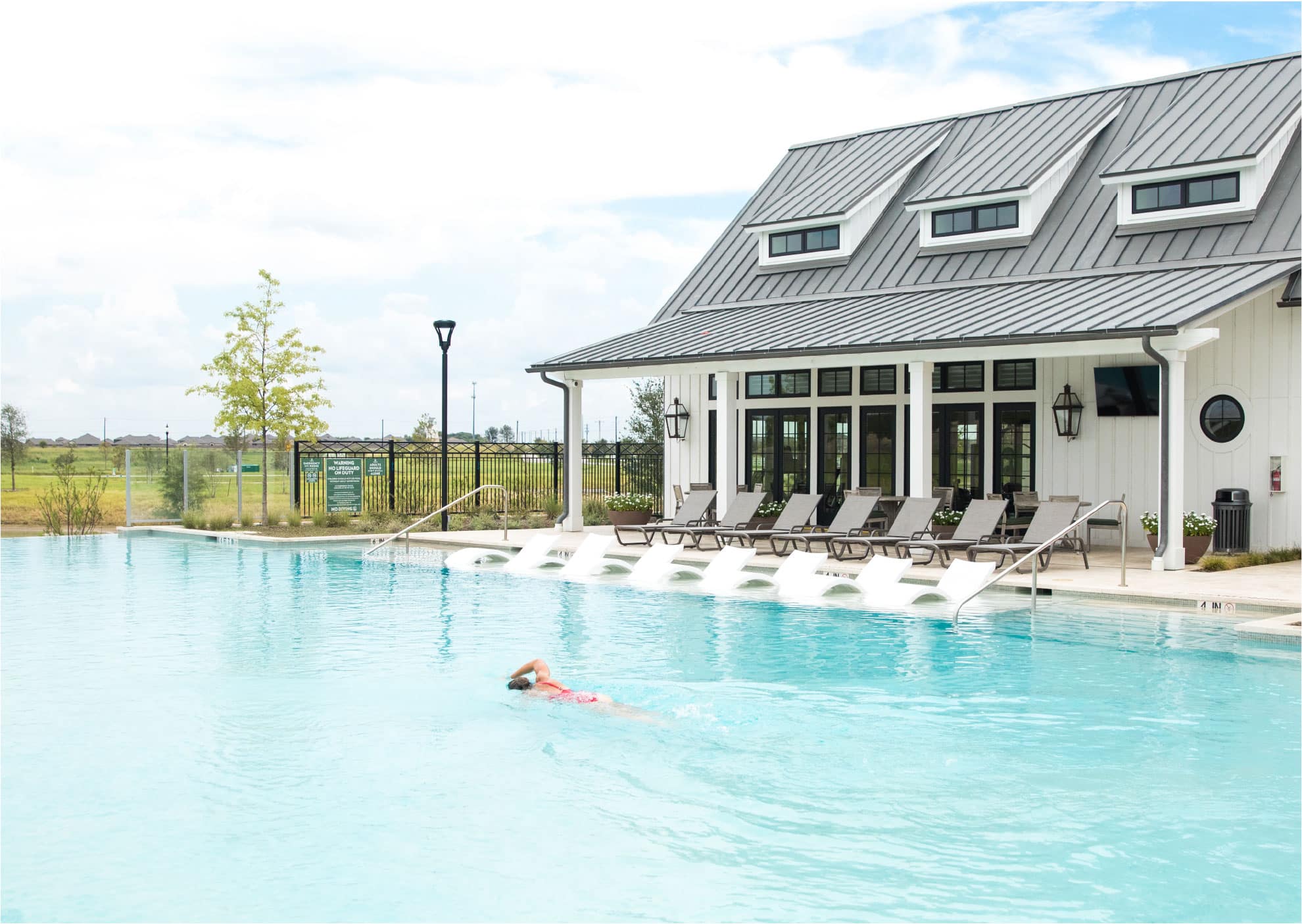 woman swimming laps at the pool at The Carriage House amenity center